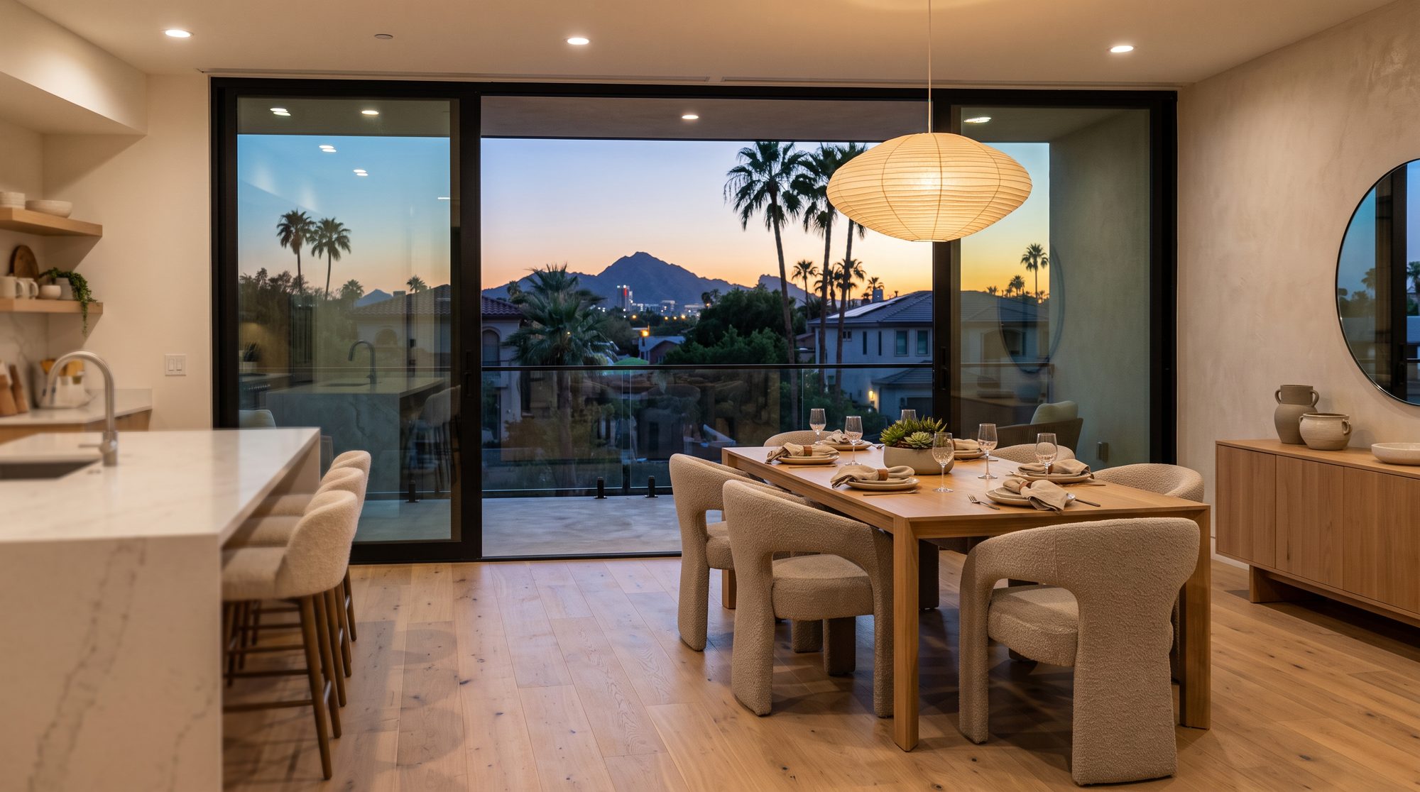 Rendering of the dining area with balcony doors open to a dusk view over Phoenix